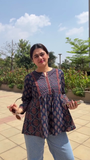 Women’s Floral Printed Peplum Top with Three-Quarter Sleeves, Front Tie Detailing, and Round Neck in Red and Blue Variants Paired with Stylish Blue Denim Jeans – Casual Ethnic Fusion Wear