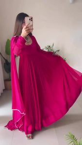 Elegant Pink Pleated Anarkali Dress with Sheer Dupatta, Traditional Silver Jewelry, and Contemporary Footwear for Festive and Special Occasions
