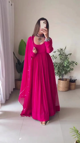 Elegant Pink Pleated Anarkali Dress with Sheer Dupatta, Traditional Silver Jewelry, and Contemporary Footwear for Festive and Special Occasions