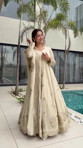 Elegant Beige Lehenga Choli with Intricate Golden Embroidery, Scalloped Hem, and Coordinating Dupatta, Perfect for Weddings and Festive Celebrations